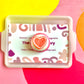 White Icing with Pink Heart Gummy Cookie