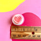 White Icing with Pink Heart Gummy Cookie